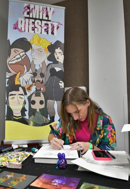 Artist Emily Riesett at work on a picture at the Melbourne Toy and Comic Con at the Melbourne Auditorium. The colorful event featured over 60 vendors, popular comic book artists, cosplayers, contests, panels, and several Hollywood guests.