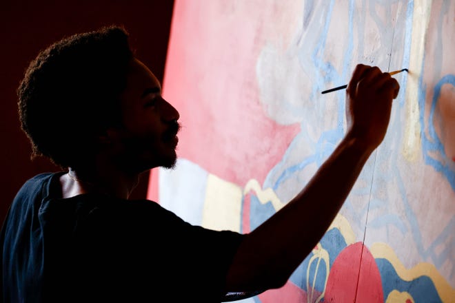 Huey Robinson paints his piece “Look both ways before you cross my mind” for the Fresh Paint mural project in Oklahoma City, on Monday, March 4, 2024.