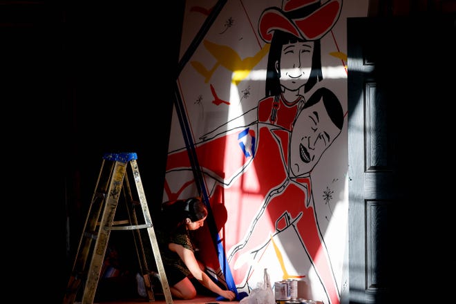 Esther Velasco paints her piece "Happiness" for the Fresh Paint mural project in Oklahoma City, on Monday, March 4, 2024.