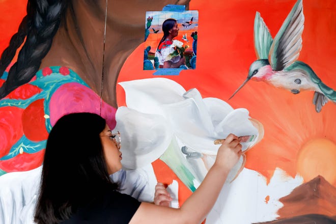 Adamaris Rodriguez paints her piece "Para Adelante" for the Fresh Paint mural project in Oklahoma City, on Monday, March 4, 2024.