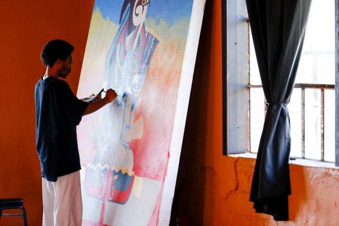 Huey Robinson paints his piece “Look both ways before you cross my mind” for the Fresh Paint mural project in Oklahoma City, on Monday, March 4, 2024.