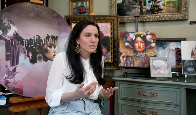 Wall High School art teacher Jill Alexander is shown amongst her work in her home studio Tuesday, April 23, 2024. While participating in an art show in Denver, four of her paintings were stolen.