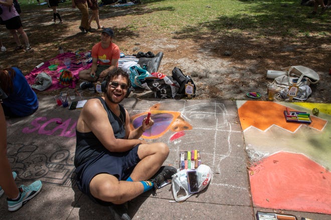 Cameron Mason, poses for a picture at the SCAD Sidewalk Arts Festival, on April 27, 2024, in Savannah, GA.
