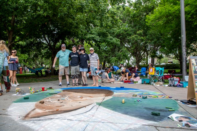 Matt Mossholder, Eric Leidenroth, Marilyn Leidenroth, Steven Batson, and Troy Wingard, showcase the biggest chalk piece, at the SCAD Sidewalk Arts Festival, on April 27, 2024, in Savannah, GA.
