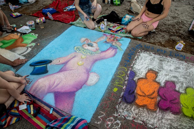 Students draw a bunny with a top hat, at the SCAD Sidewalk Arts Festival, on April 27, 2024, in Savannah, GA.