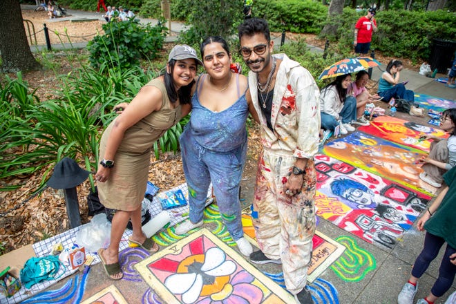 Vivek Gupta, Devika Menon, and Tanya Shah pose for a picture at the SCAD Sidewalk Arts Festival, on April 27, 2024, in Savannah, GA.