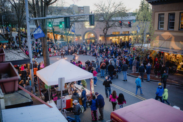 huge crowds of people milling under pop up tents in downtown Olympia