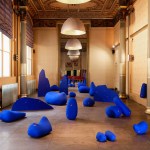 Installation view of blue sculptures in a French hallway.