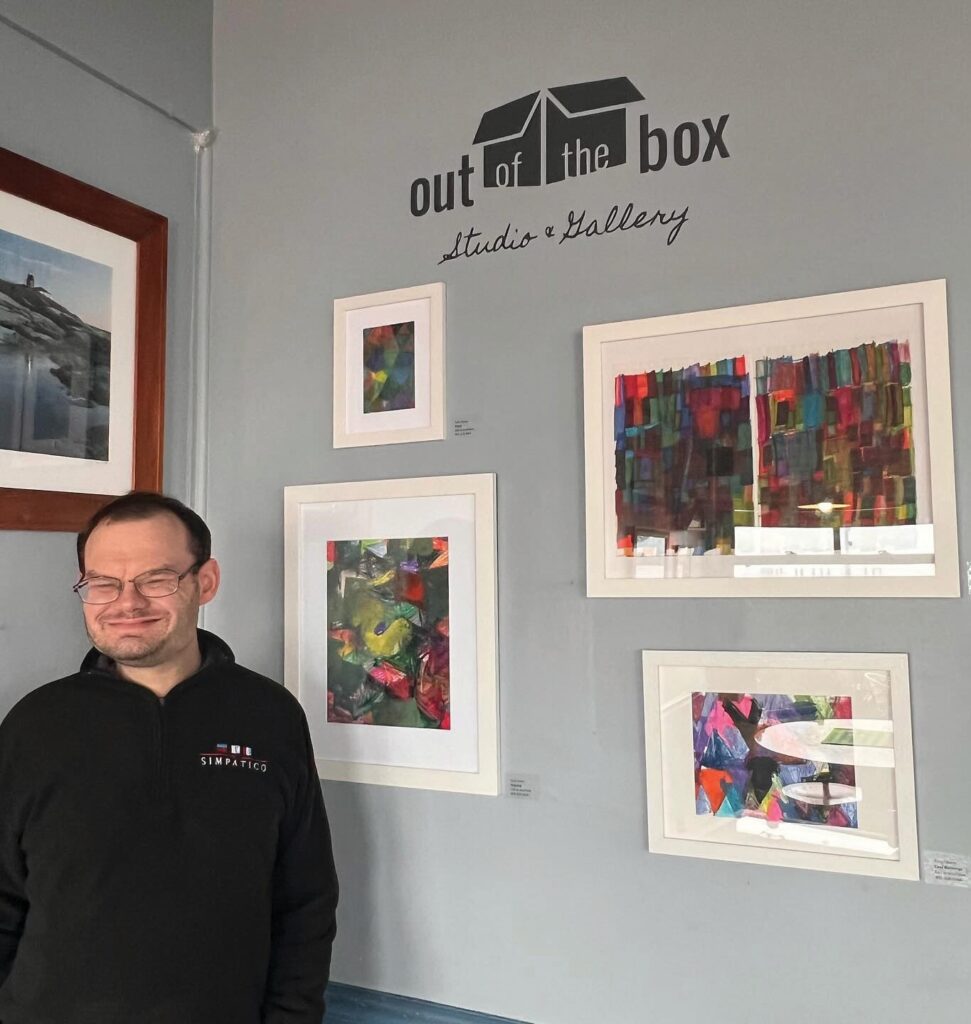 Out of the Box artist Tony Chece stands by his drawings at the studio’s new gallery at East Ferry Deli. The restaurant and studio will rotate the exhibitions on a monthly or bimonthly basis.