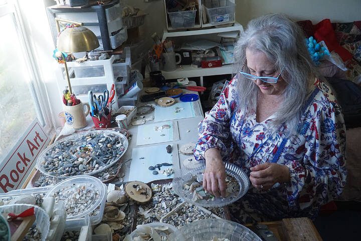 Artist Libby Hammer picks through bits and pieces collected from Whidbey Island beaches recently at her home in Oak Harbor. (Sam Fletcher / Whidbey News-Times)