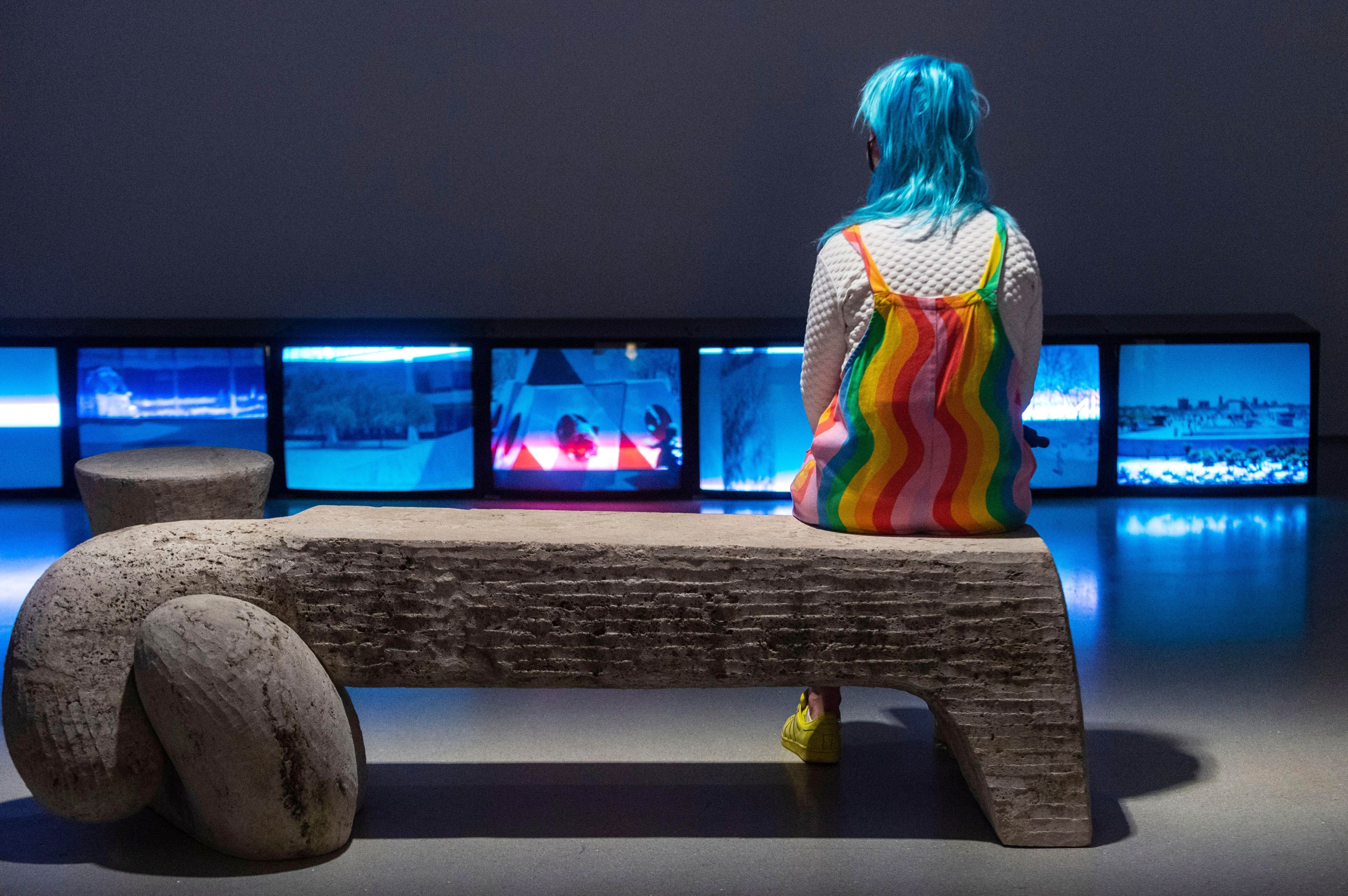 A visitor sits on Bench by Isamu Noguchi at the Barbican Art Gallery (Alamy)