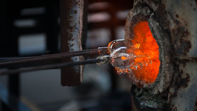 Ryan Gothrop gives a glass blowing demonstration during Artisphere in downtown Greenville on Friday, May 13, 2016.