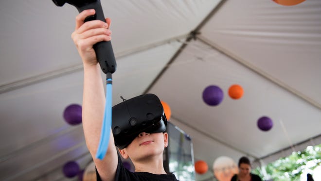 William Pool, 10, plays a virtual reality game at Clemson's STEAM exhibit on the first day of Artisphere in downtown Greenville on Friday, May 12, 2017.