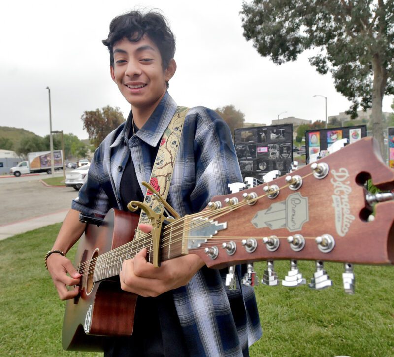 Alvin Gonzalez, rehearses on his guitar before performing during the Day of Artist and Poet Festival at Bowman High School in Santa Clarita on Wednesday, 051524.  Dan Watson/The Signal