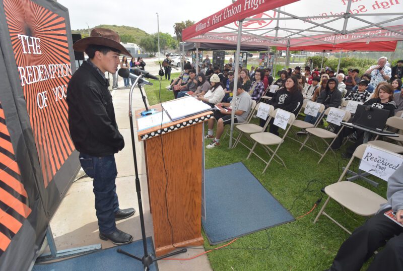 Aaron Nava reads his poem "Padre Mia"  during the Day of Artist and Poet Festival at Bowman High School in Santa Clarita on Wednesday, 051524.  Dan Watson/The Signal