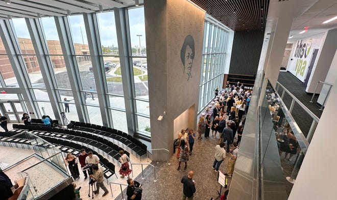 Guests mingle in the grand lobby of the new Booker Visual and Performing Arts Center before a ribbon-cutting ceremony Thusday for the new $28 million facility.