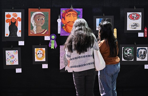 People look at art on display during the 4th Annual Solano Student Art Showcase hosted by the Solano County Office of Education on Saturday at the Solano County Fairgrounds. (Chris Riley/Times-Herald)