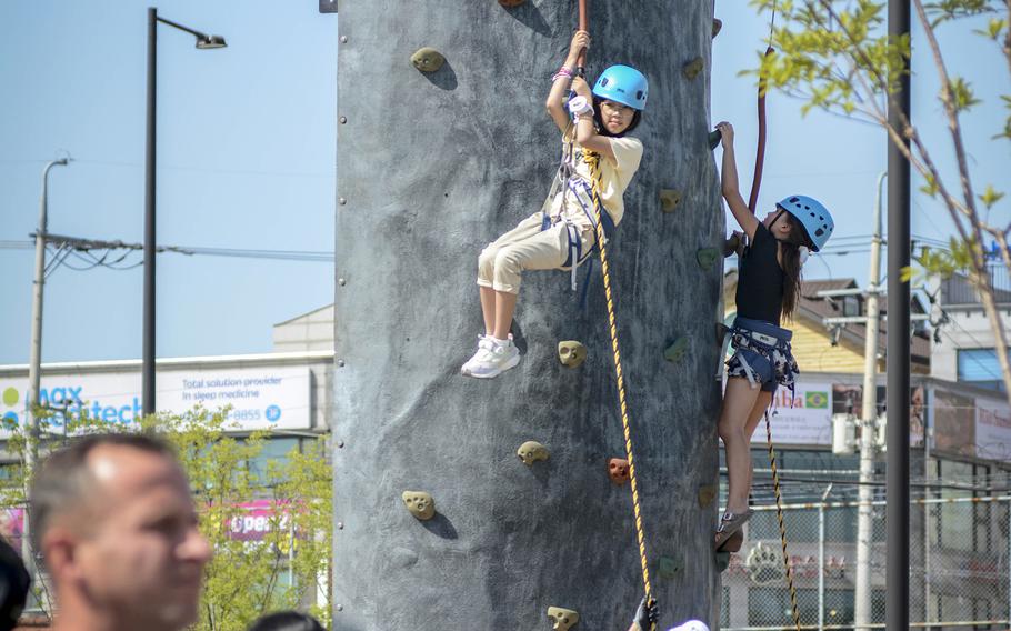 Chidren try out a rock-climbing wall during Spring Fest at Camp Humphreys, South Korea, May 18, 2024.