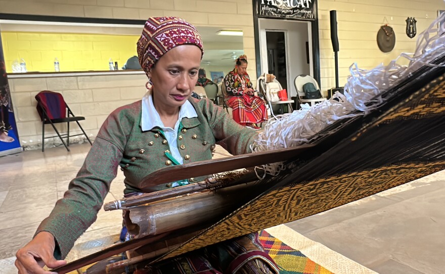 Otong works at her backstrap loom.