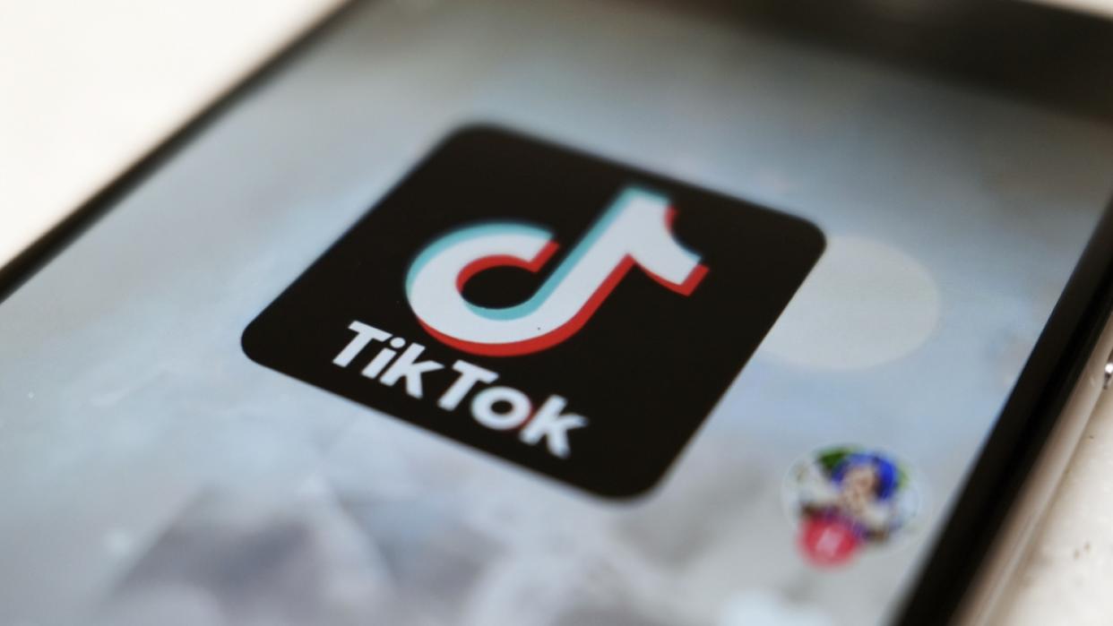 The TikTok logo displayed on a smartphone.