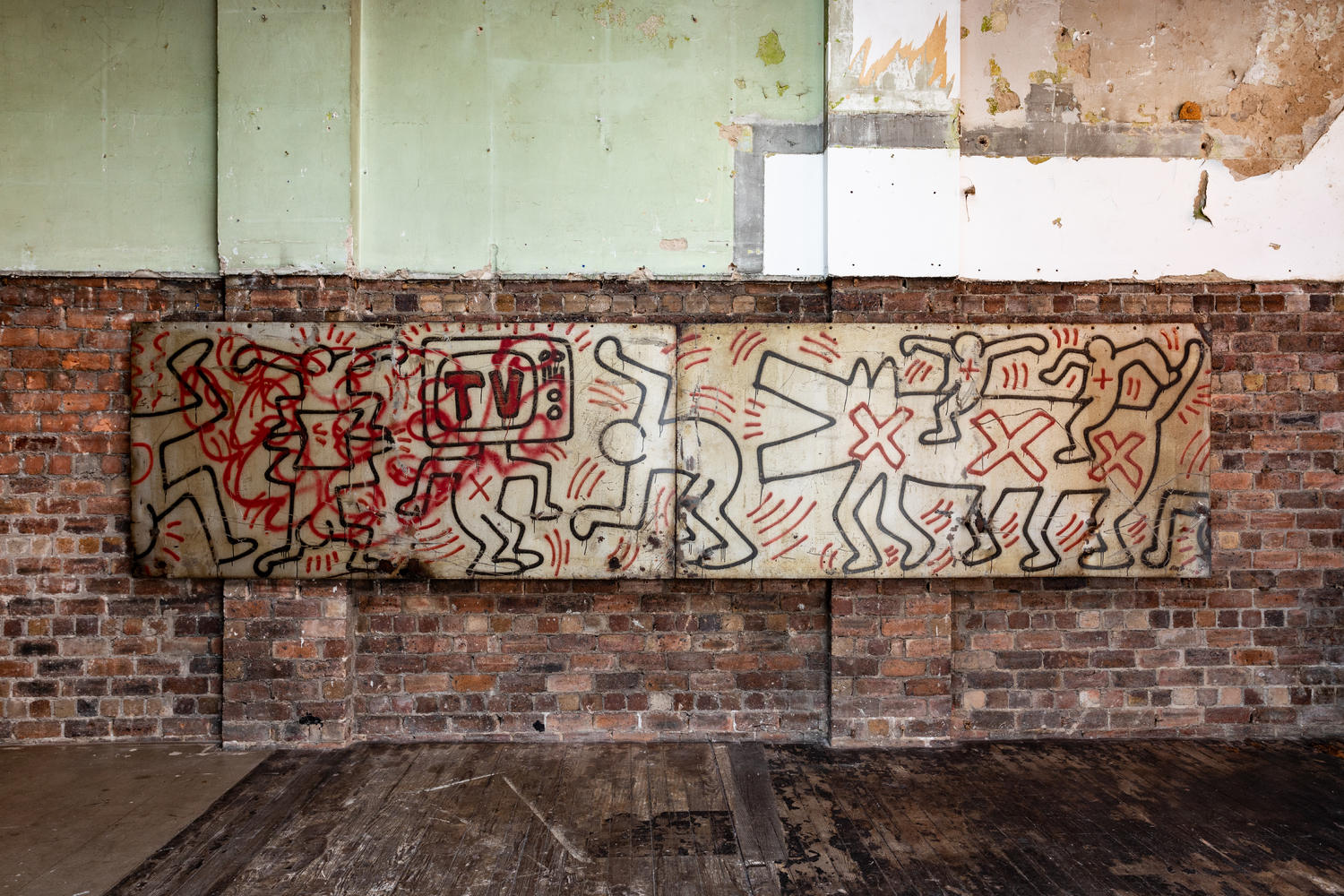 A simply drawn line-art mural by Keith Haring