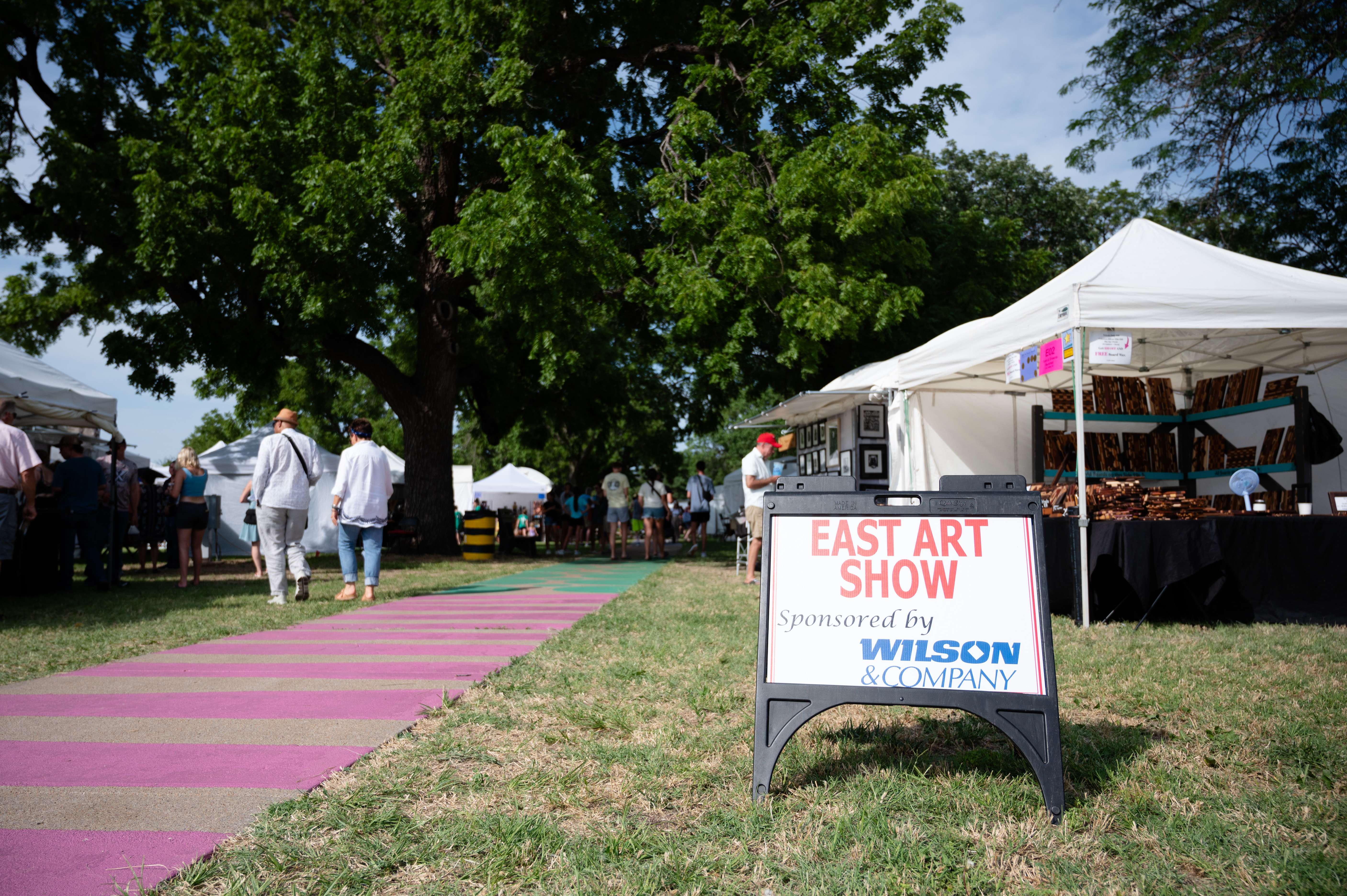 Visitors browse the East Art Show at the Smoky Hill River Festival on Friday, June 14, at Oakdale Park in Salina. <b>Photo by Olivia Bergmeier</b>