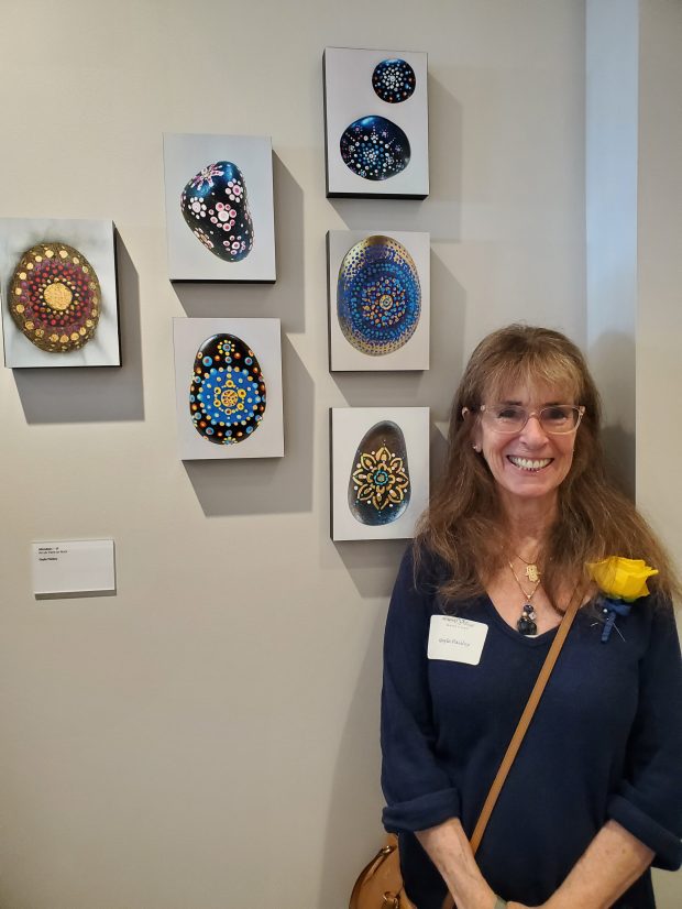 Artist Gayle Paisley stands with her art pieces. (Ashley Mackin-Solomon)