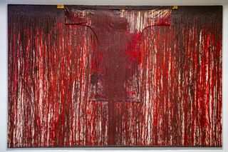 Artwork of white canvas and t-shirt covered in red paint, as if blood