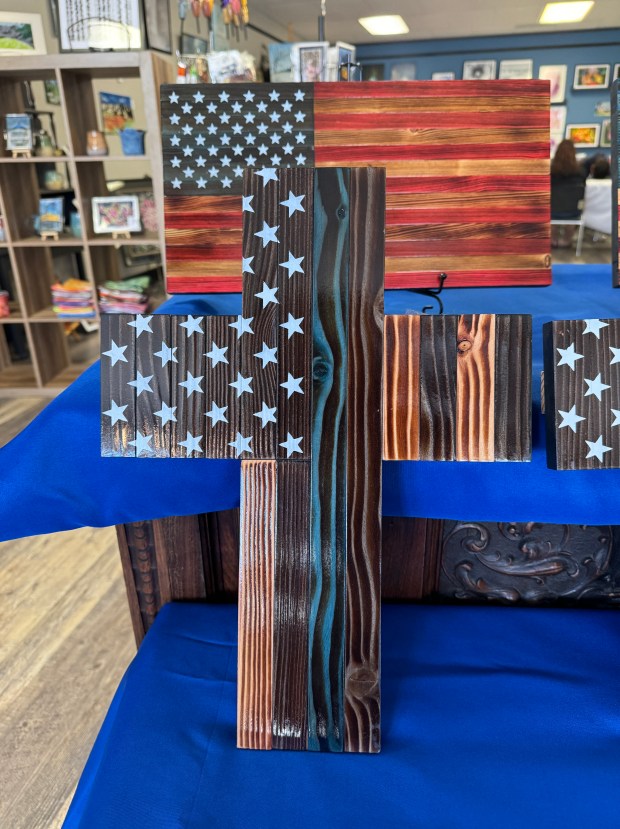 A fractal burn flag and a thin blue line cross are among the creations made by Sterling Creatives' featured artist Bryan Askew. (Callie Jones/Journal-Advocate)