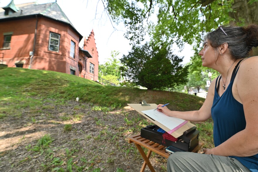 Michelle Tulumullo sketches the Towanda Public Library during the Susquehanna Solstice Festival's plein air painting.