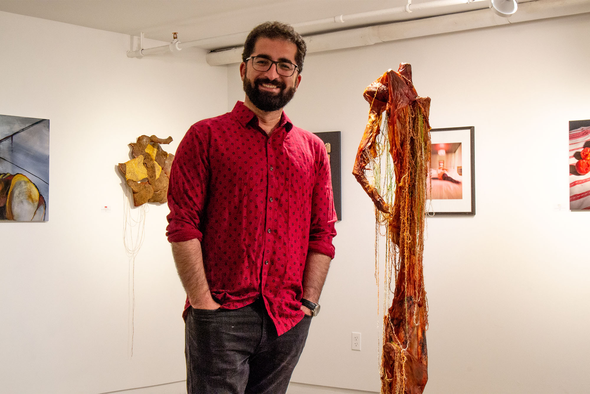 Kamal Ahmad (CFA’16) standing inside Piano Craft Gallery, where he is the curator and director.