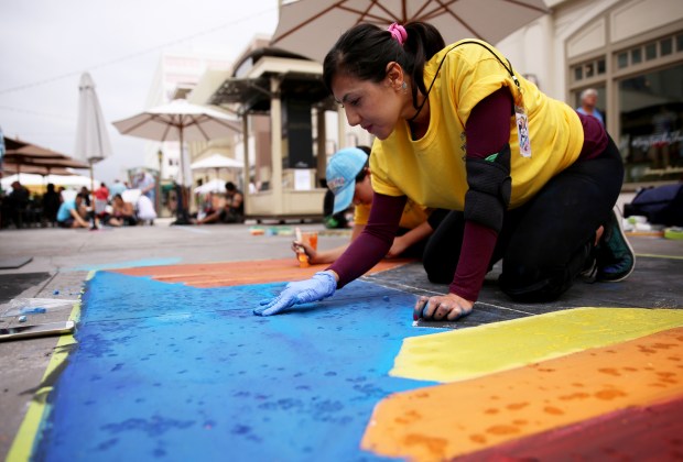 Maria Martinez, 39, works on her chalk art during the annual Pasadena Chalk Festival at the Paseo Colorado in Pasadena on Saturday, June 16, 2018. (Photo by Trevor Stamp, Contributing Photographer)