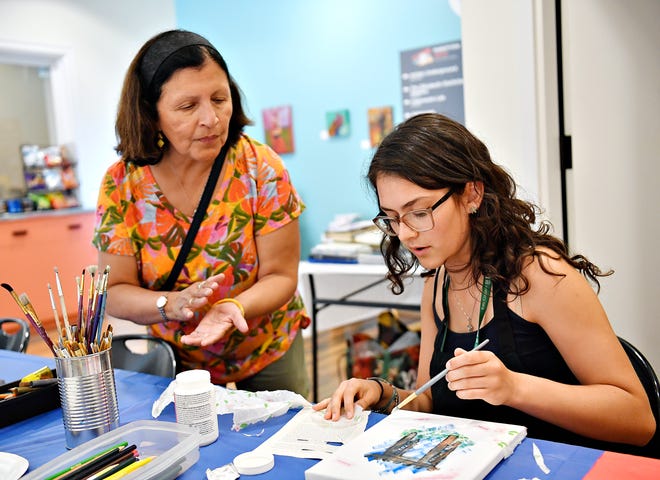 Local artist and art therapist Rosa Luz Catterall, left, talks to Melody Leubecker, of Spring Garden Township, during her monthly art wellness activity at Marketview Arts in York City, Saturday, July 6, 2024. (Dawn J. Sagert/The York Dispatch)