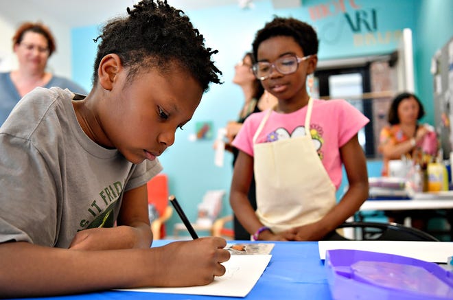 Irisa Zitrick, 7, looks on as her brother Stephen Zitrick, 10, both of Mount Wolf, starts his drawing while both participate in local artist and art therapist Rosa Luz Catterall’s monthly art wellness activity for the first time, at Marketview Arts in York City, Saturday, July 6, 2024. (Dawn J. Sagert/The York Dispatch)