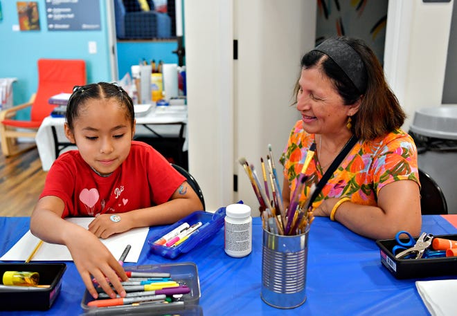 Local artist and art therapist Rosa Luz Catterall, right, looks on as Patricia Geesey, 9, of Manchester, selects a color to begin her project with during Luz Catterall’s monthly art wellness activity at Marketview Arts in York City, Saturday, July 6, 2024. The next activity, themed “Expressions of Fun” will be on Aug. 24. (Dawn J. Sagert/The York Dispatch)