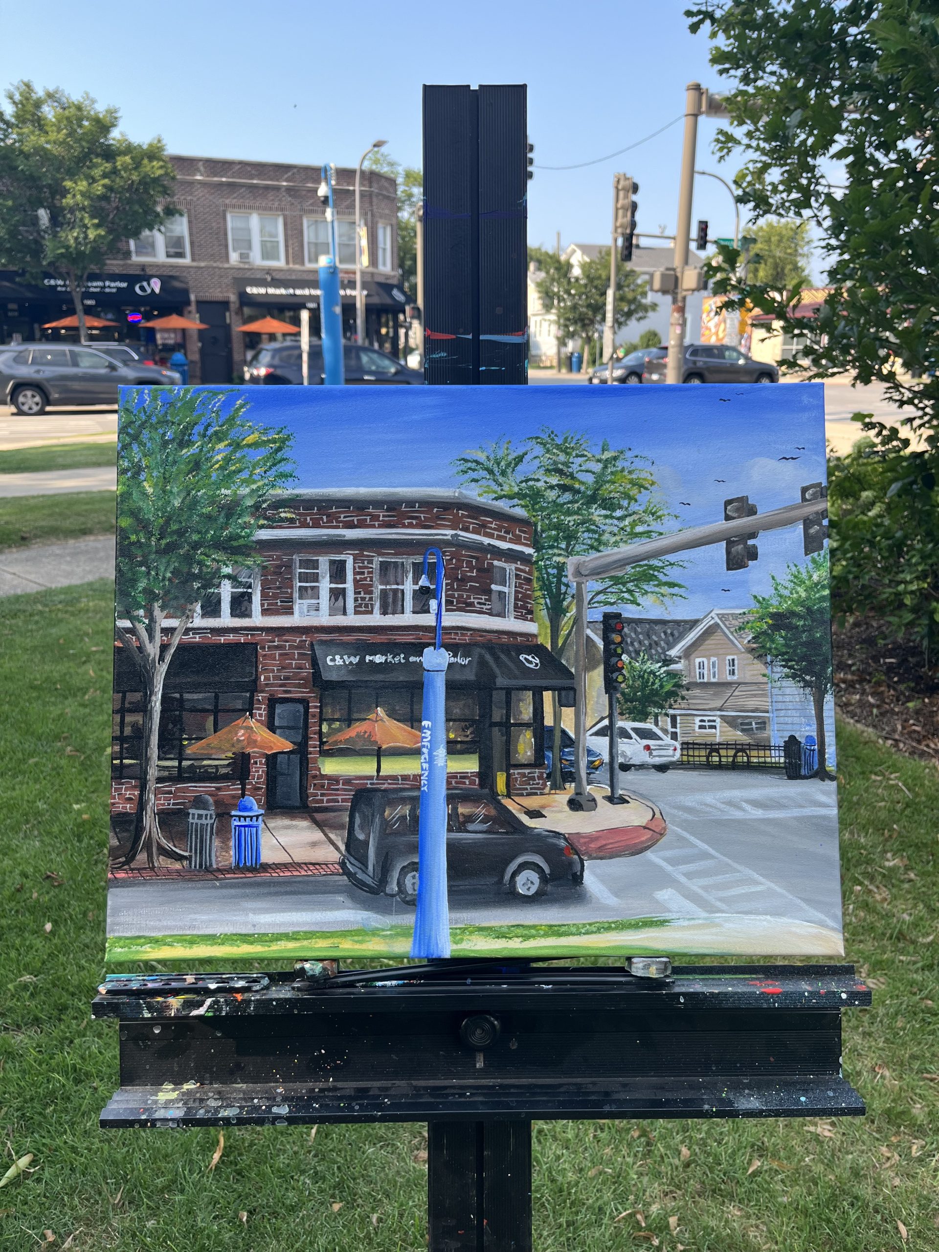 painting of intersection on easel in front of intersection