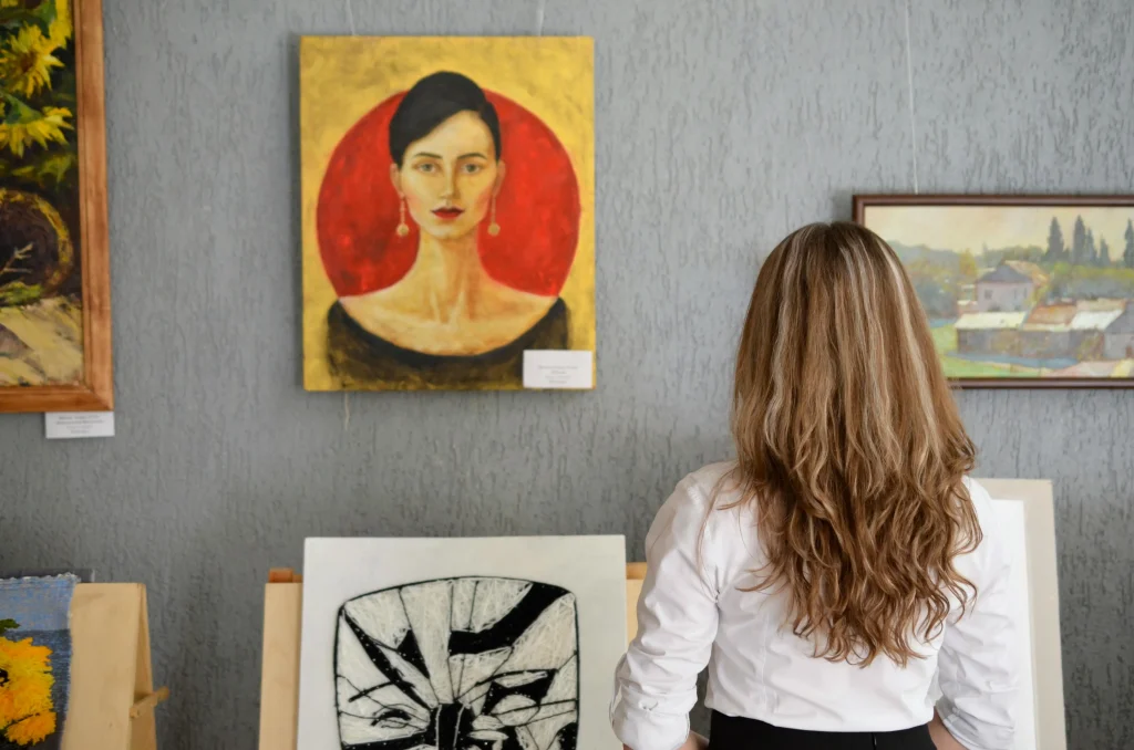 woman looking at art investing hobby pexels