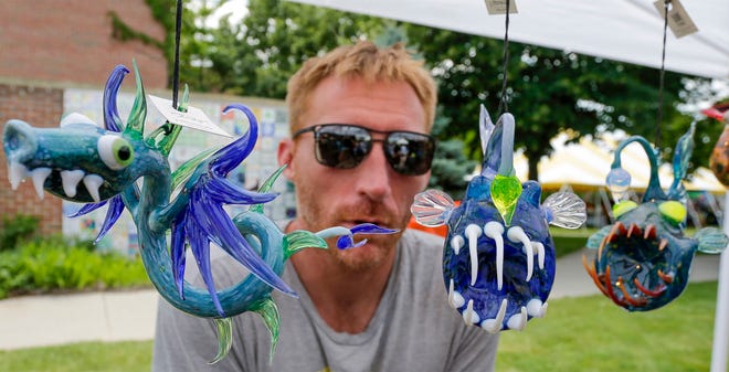 Glass artist Justin Straub of West Bend, Wis., with some of his art during the John Michael Kohler Arts Center’s Midsummer Festival of the Arts, Saturday, July 20, 2024, in Sheboygan, Wis.