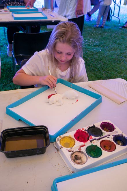 Vivian Hagerman, 8, paints onto clay at the children’s activity tent during the John Michael Kohler Arts Center’s Midsummer Festival of the Arts, Saturday, July 20, 2024, in Sheboygan, Wis.