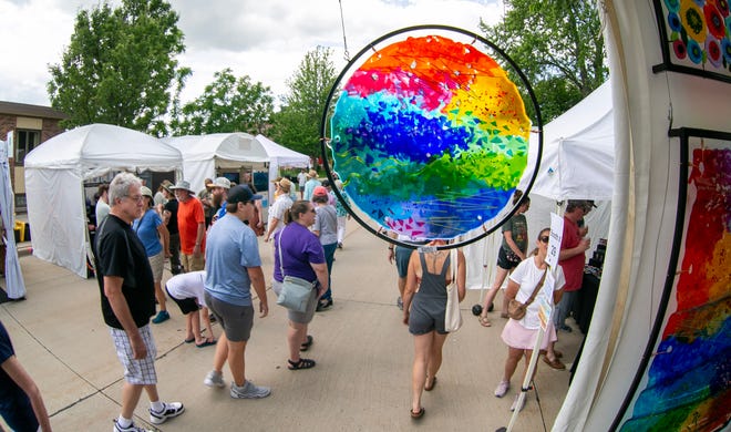 Glass art bylaws Lisa Mote of Newborn, Georgia, hang at her booth during the John Michael Kohler Arts Center’s Midsummer Festival of the Arts, Saturday, July 20, 2024, in Sheboygan, Wis.