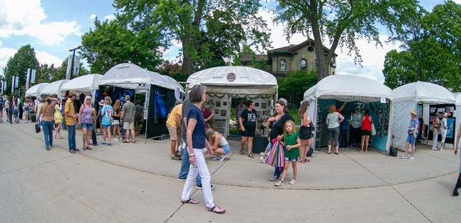 People walk around the block to see the artists offerings during the John Michael Kohler Arts Center’s Midsummer Festival of the Arts, Saturday, July 20, 2024, in Sheboygan, Wis.