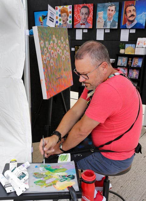 Sheboygan artist Jason Kotecki works on a painting at his booth during the John Michael Kohler Arts Center’s Midsummer Festival of the Arts, Saturday, July 20, 2024, in Sheboygan, Wis.