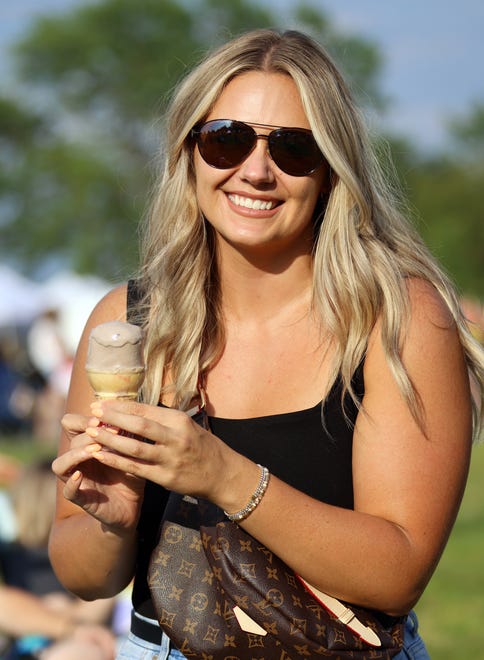 McKenna Beaty enjoys an ice cream cone during the Waukee Arts Festival on Saturday, July 20. The two-day event at Centennial Park featured local artists and music.