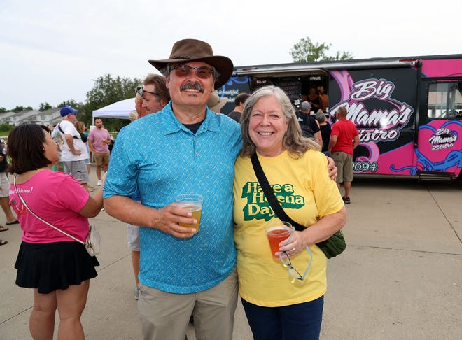 Mike and Sherry Schlundt of Ankeny enjoy the Waukee Arts Festival on Friday, July 19. The two-day festival at Centennial Park featured local artists and live music.