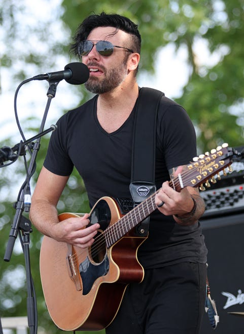 Musical artist Dan Medeiros plays his 12-string guitar during the Waukee Arts Festival on Saturday, July 20. The two-day festival at Centennial Park featured local artists and live music.