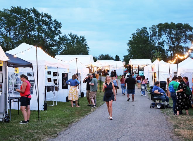 Art shoppers enjoy the Waukee Arts Festival on Friday, July 19. The two-day festival at Centennial Park featured local artists and live music.