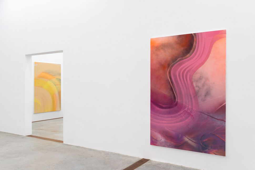 Photo of a room with pink and yellow abstractions 