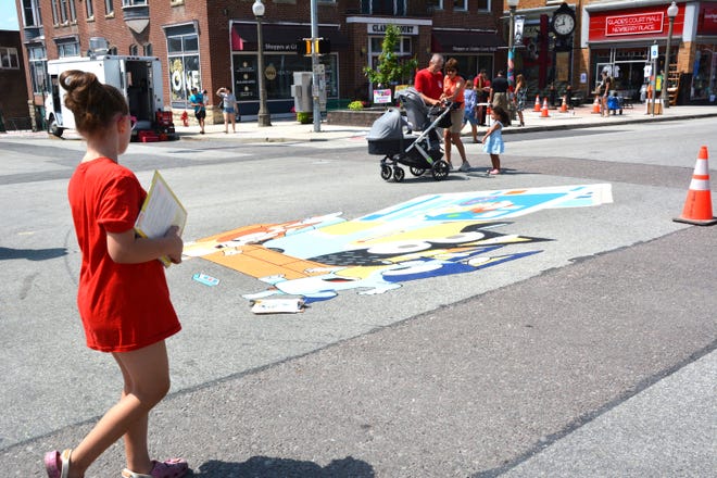 The Chalking Dad, Erik Greenawalt's art gathered plenty of attention from festival-goers right on the Diamond in Uptown Somerset Sunday.