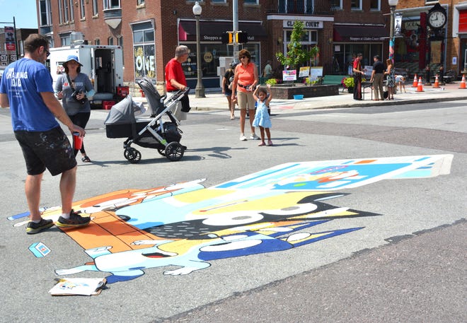 The Chalking Dad, Erik Greenawalt's art gathered plenty of attention from festival-goers right on the Diamond in Uptown Somerset Sunday.