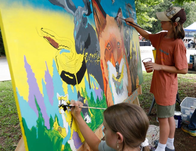 Local kids help paint a mural with local artist Will Eskridge at FoxSaid Festival at the Cotton Press in Athens, Ga., on Saturday, July 27, 2024. The mural is part of an Athens Downtown Development Art Decko project. It will be placed inside the downtown College Avenue parking deck stairwell.